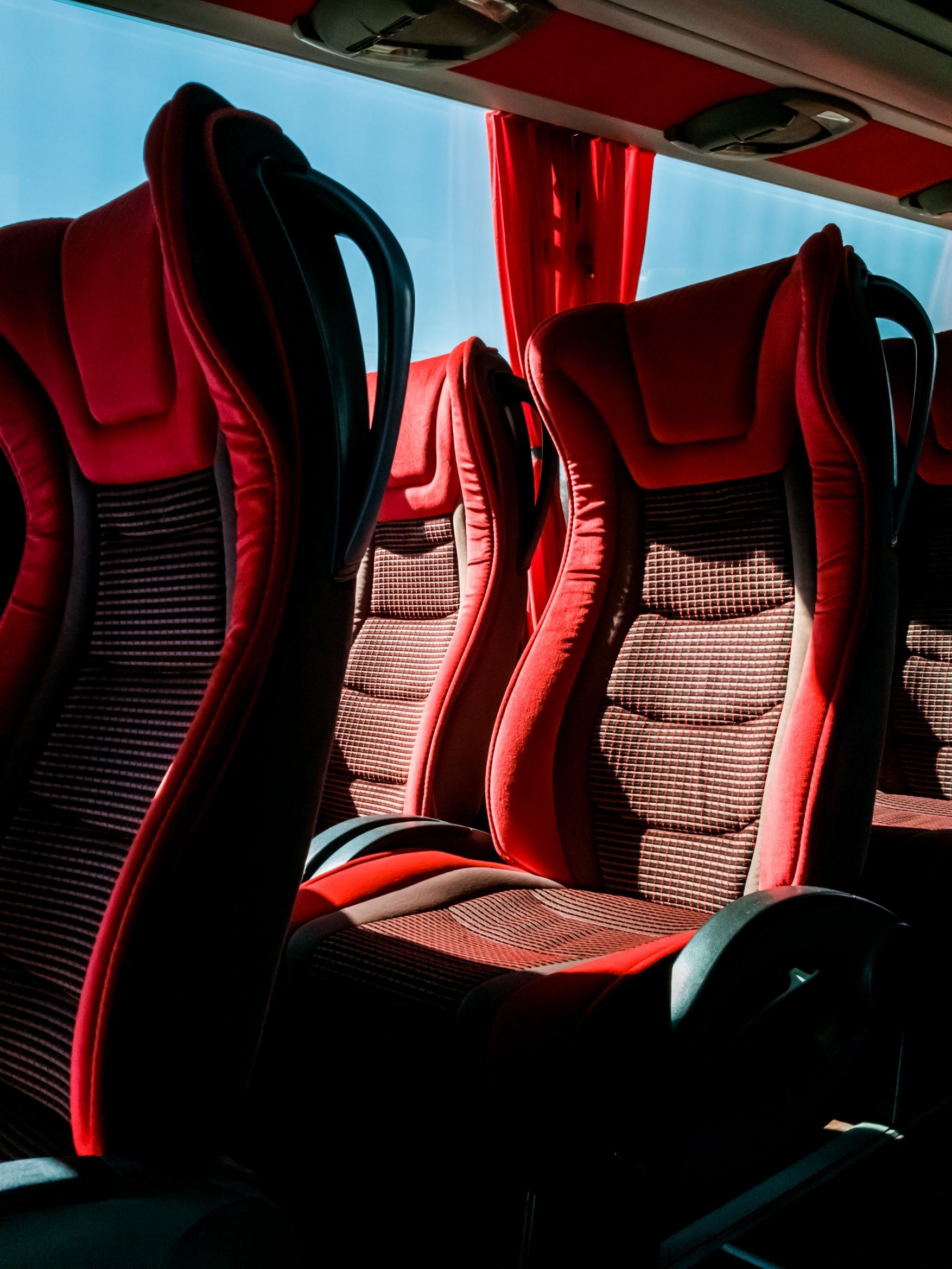 Closeup of red comfortable seats inside tourist bus
